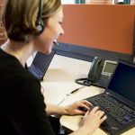 woman on a telephone and keyboard